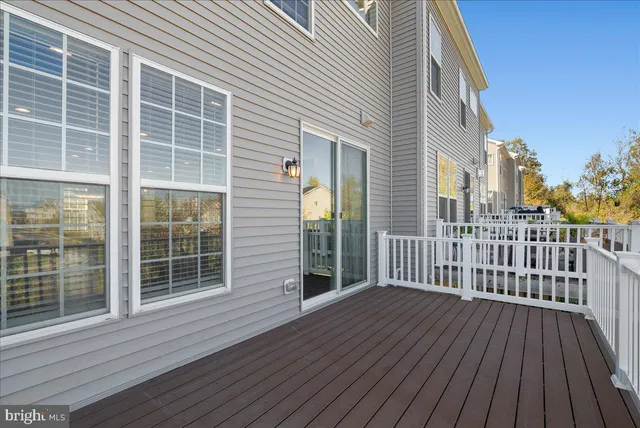a view of a house with a wooden deck