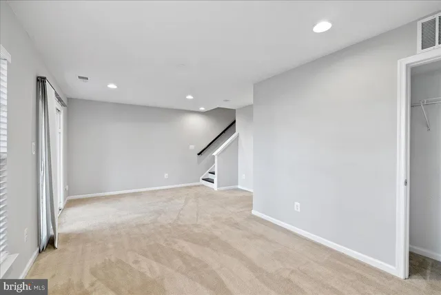 a view of an empty room and glass door