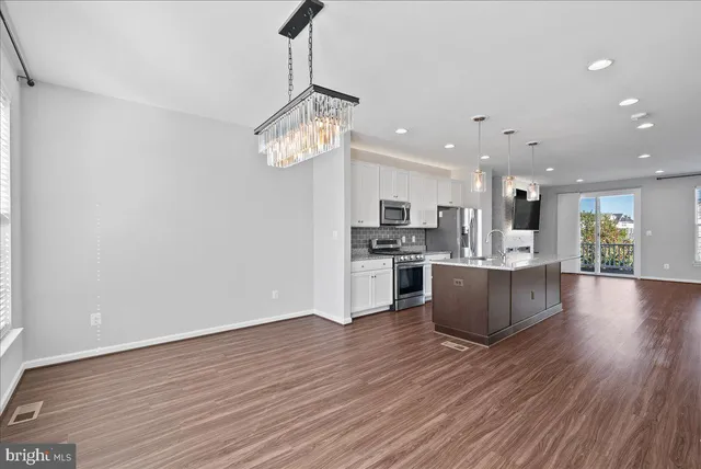 a view of kitchen and kitchen with wooden floor