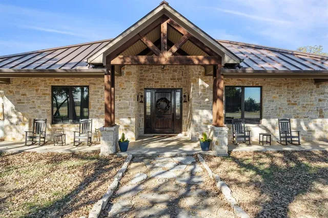 a front view of a brick house with large windows