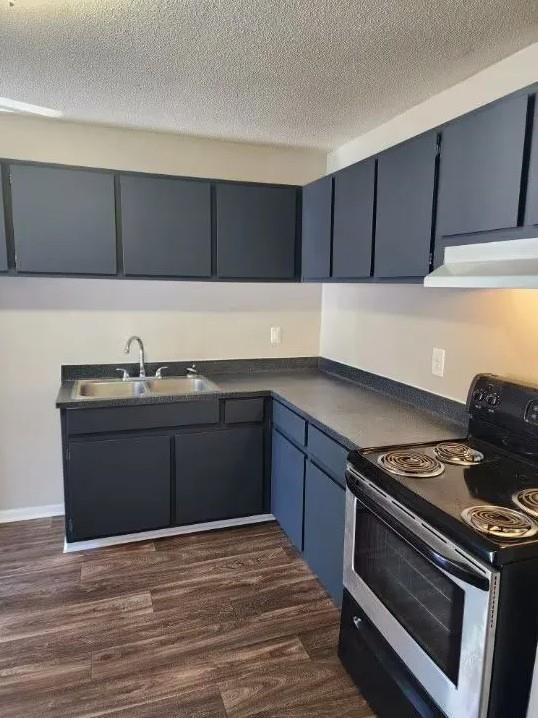 a kitchen with granite countertop a stove and a sink