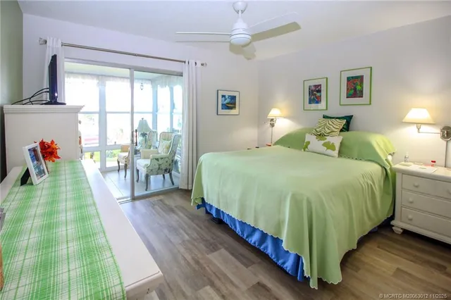 a spacious bedroom with a bed and a chandelier