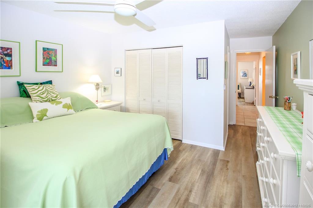 2929 Southeast Ocean Boulevard, Unit 1189 Stuart, FL 34996 - Photo 14 of 34 a bedroom with a bed and a chandelier