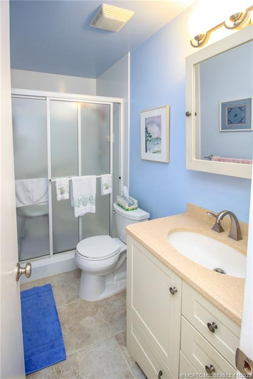 2929 Southeast Ocean Boulevard, Unit 1189 Stuart, FL 34996 - Photo 15 of 34 a bathroom with a sink a toilet and shower