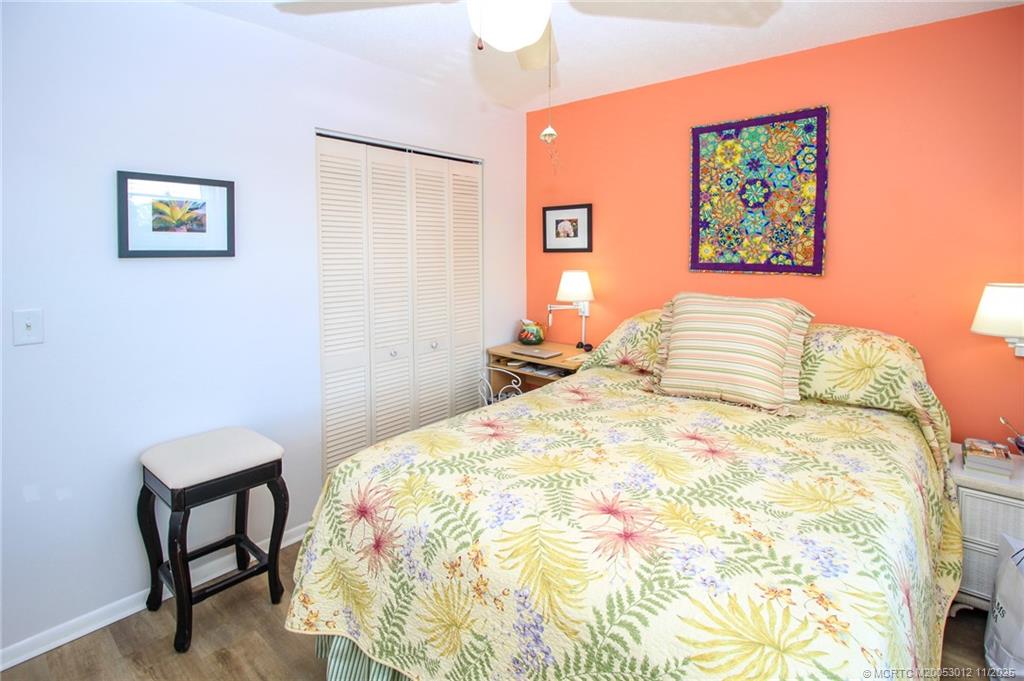 2929 Southeast Ocean Boulevard, Unit 1189 Stuart, FL 34996 - Photo 17 of 34 a bedroom with a bed and a painting on the wall