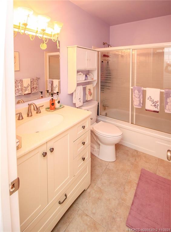 2929 Southeast Ocean Boulevard, Unit 1189 Stuart, FL 34996 - Photo 19 of 34 a bathroom with a double vanity sink toilet and shower