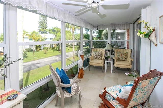a living room with furniture and a floor to ceiling window