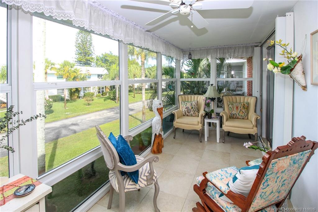 2929 Southeast Ocean Boulevard, Unit 1189 Stuart, FL 34996 - Photo 20 of 34 a living room with furniture and a floor to ceiling window