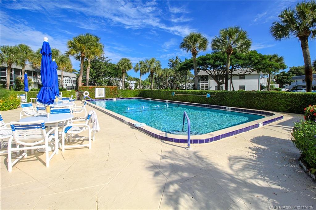 2929 Southeast Ocean Boulevard, Unit 1189 Stuart, FL 34996 - Photo 28 of 34 a view of a swimming pool with a patio