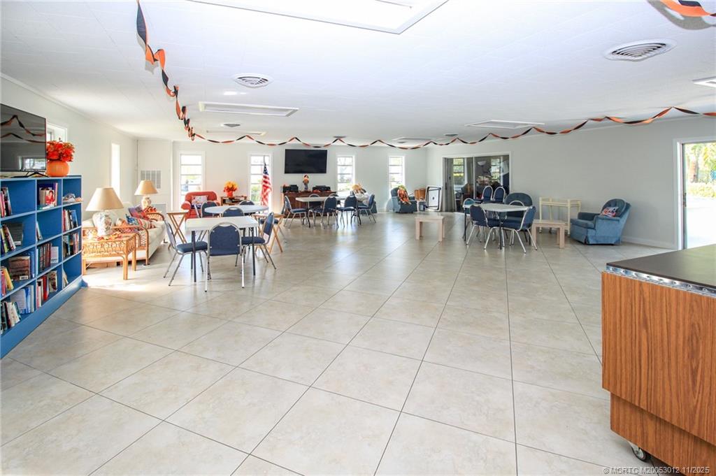2929 Southeast Ocean Boulevard, Unit 1189 Stuart, FL 34996 - Photo 30 of 34 a lobby with furniture and a book shelf