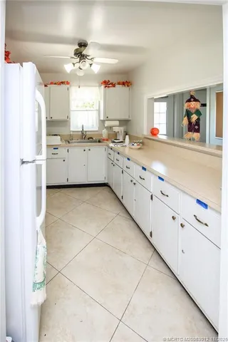 a kitchen with granite countertop a white refrigerator oven a sink and dishwasher