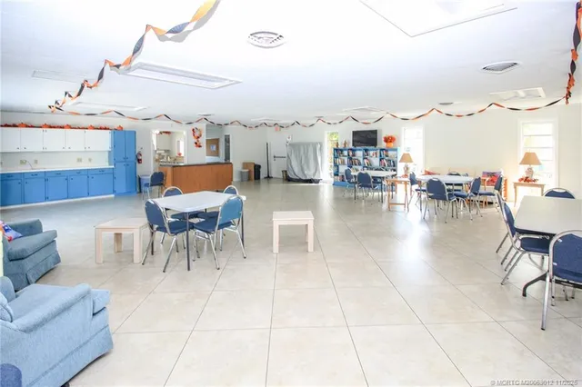 a outdoor space with lots of chairs a sink and a stove