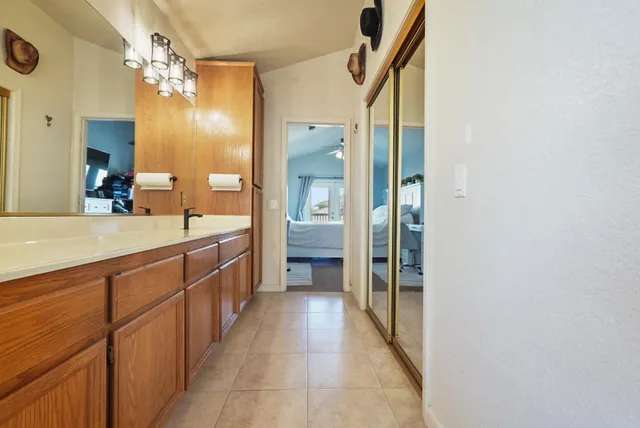 a large en suite bathroom with a double vanity sink and a mirror