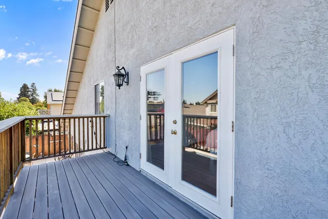 a view of a balcony with wooden floor