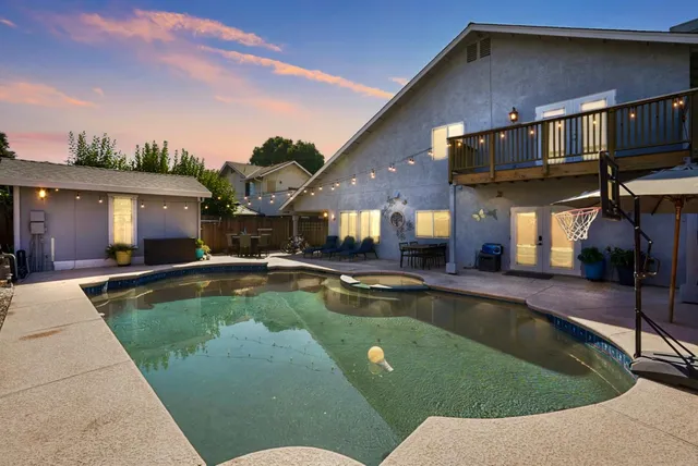 a view of a house with swimming pool in front of it