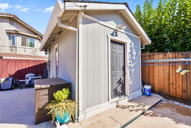 a view of a house with a patio and a yard
