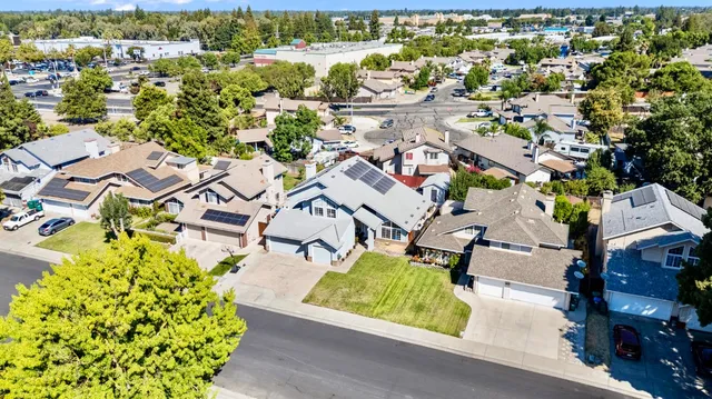 an aerial view of a swimming pool with outdoor seating