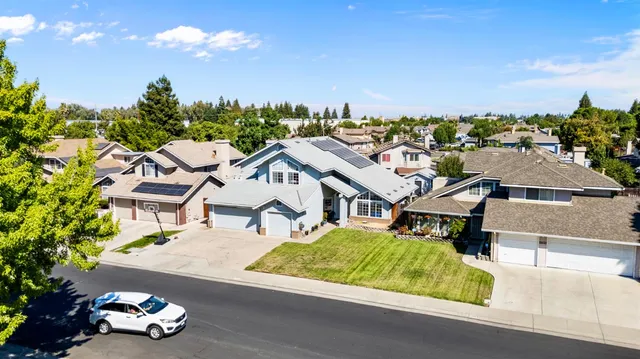 an aerial view of multiple houses with a street