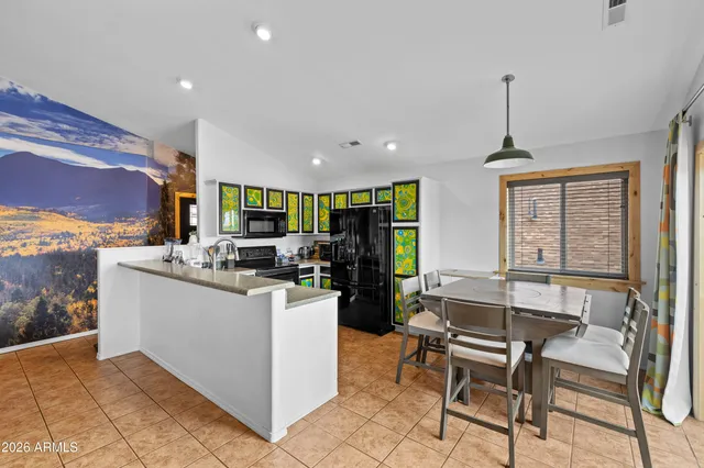 a living room with stainless steel appliances kitchen island granite countertop furniture and a kitchen view