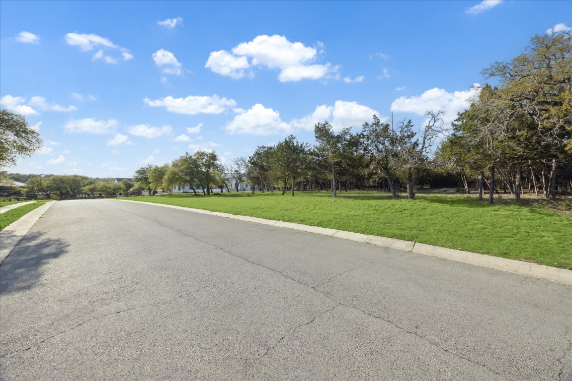 274 Waters Edge Dripping Springs, TX 78620 - Photo 5 of 9 a view of a lake with a big yard
