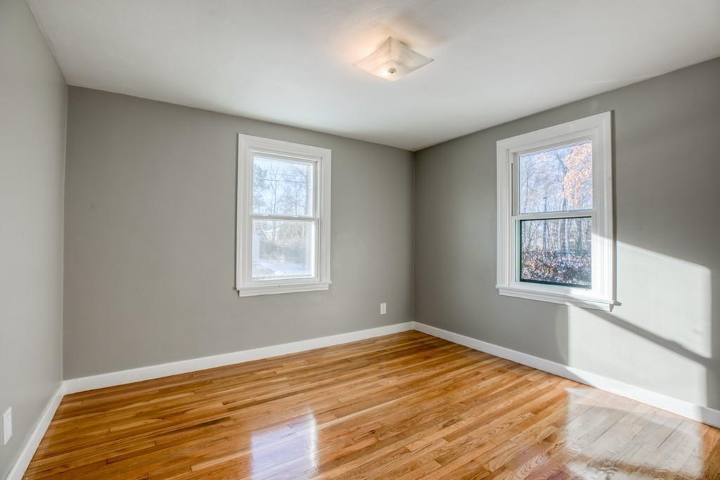 110 Gilman Street Springfield, MA 01118 - Photo 15 of 24 a view of empty room with wooden floor and fan