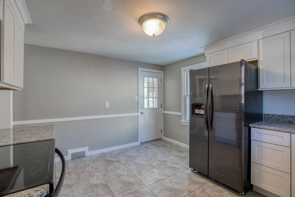 110 Gilman Street Springfield, MA 01118 - Photo 5 of 24 a kitchen with stainless steel appliances a refrigerator and a stove top oven