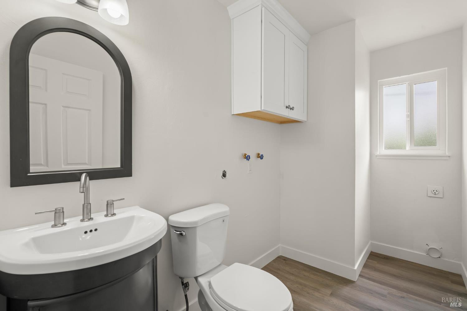 688 Grove Way Hayward, CA 94541 - Photo 16 of 20 a bathroom with a sink a toilet and mirror