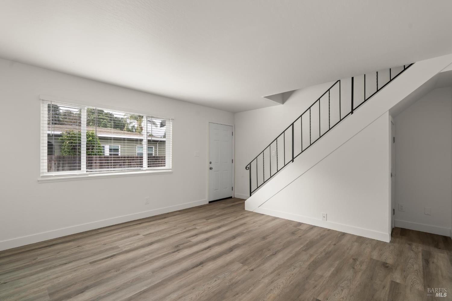 688 Grove Way Hayward, CA 94541 - Photo 19 of 20 a view of an empty room with wooden floor and a window