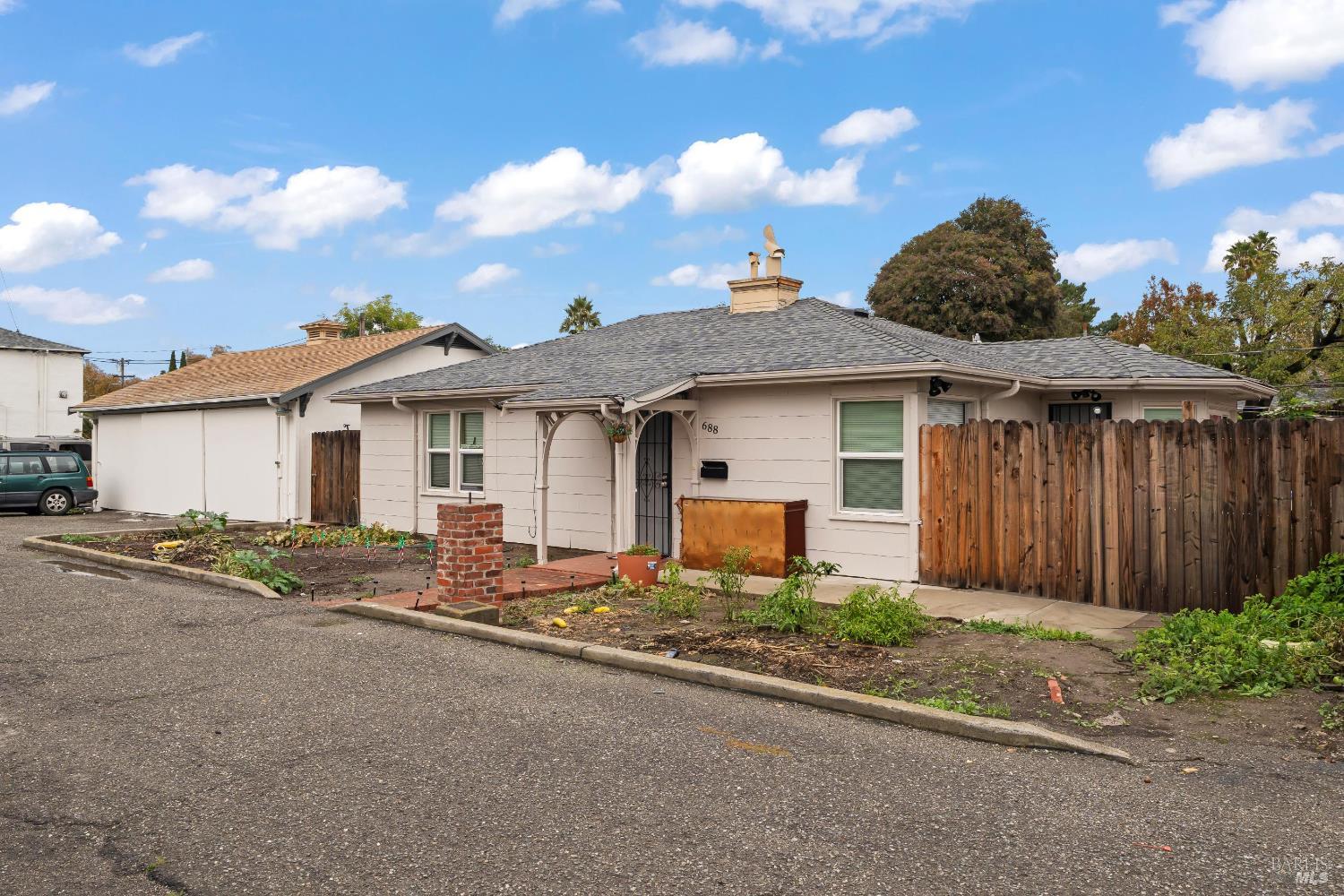 688 Grove Way Hayward, CA 94541 - Photo 6 of 20 a front view of a house with a garden and yard