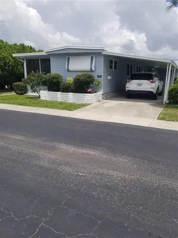 a front view of house with yard and car parked