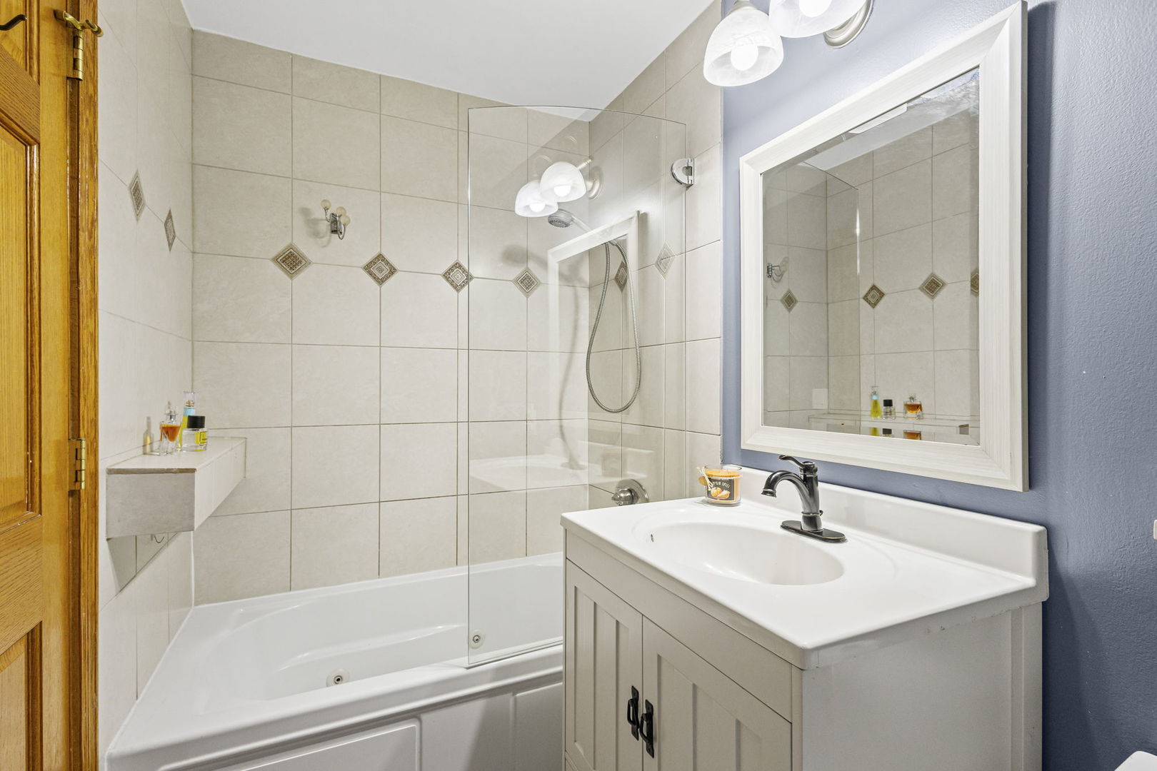 9561 Dee Road, Unit 1D Des Plaines, IL 60016 - Photo 13 of 15 a bathroom with a sink mirror and a bathtub