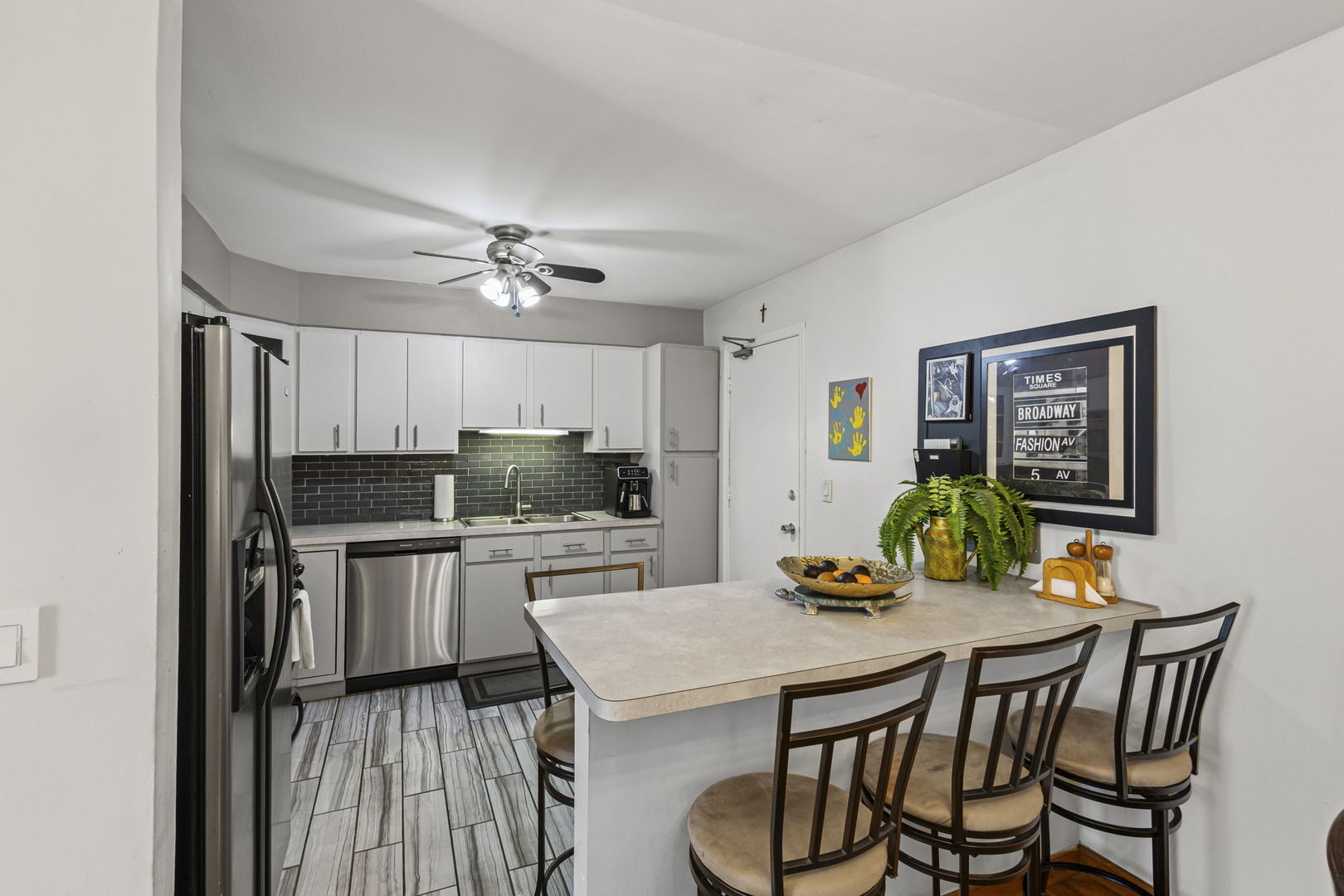 9561 Dee Road, Unit 1D Des Plaines, IL 60016 - Photo 3 of 15 a kitchen with a table chairs and refrigerator