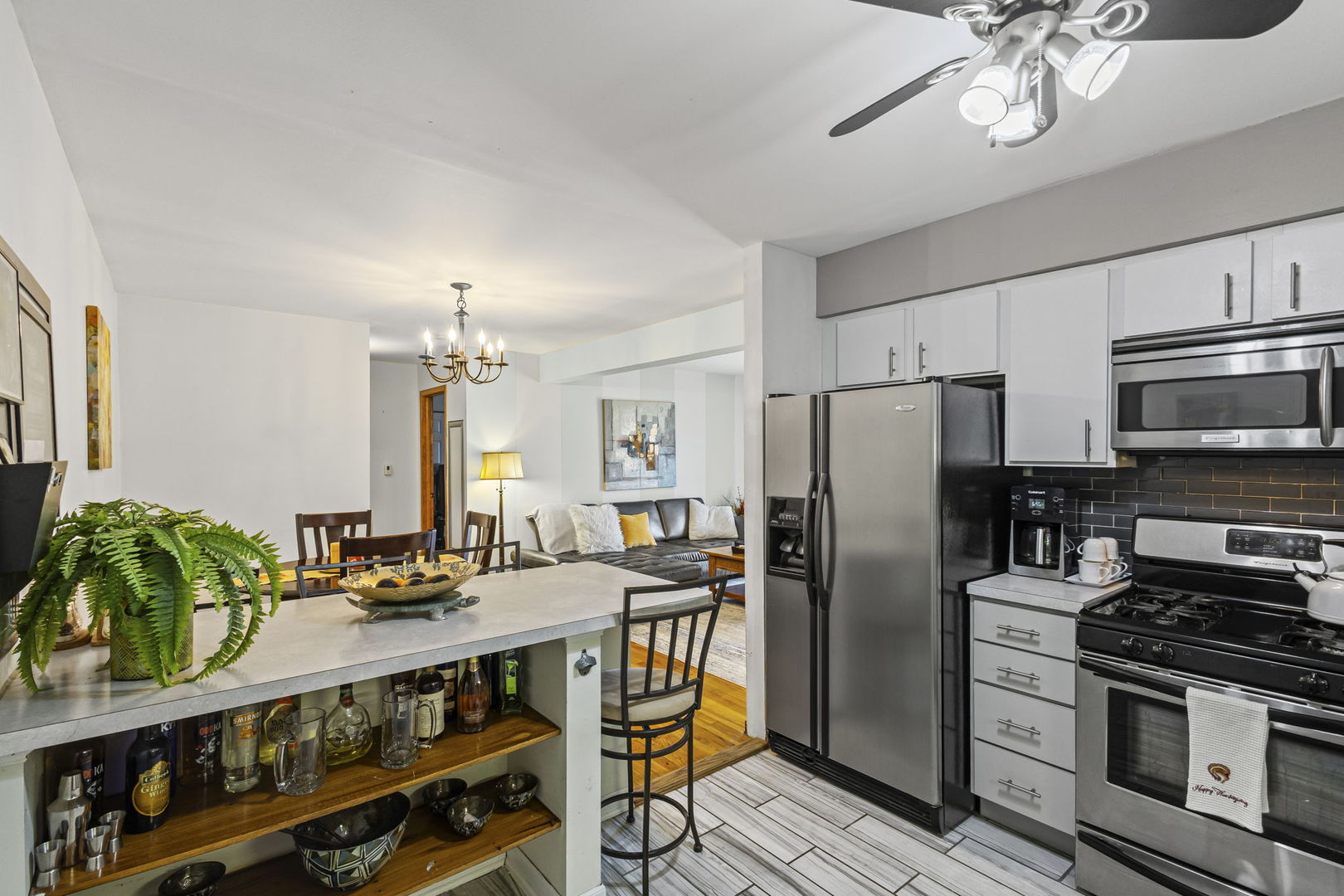 9561 Dee Road, Unit 1D Des Plaines, IL 60016 - Photo 4 of 15 a kitchen with stainless steel appliances a stove a refrigerator a kitchen island a stove and a refrigerator
