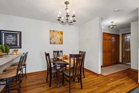 a view of a dining room with furniture and chandelier