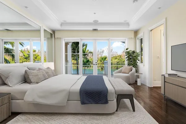 a bedroom with a bed and a potted plant
