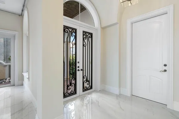 a view of staircase with white walls and floor to ceiling window