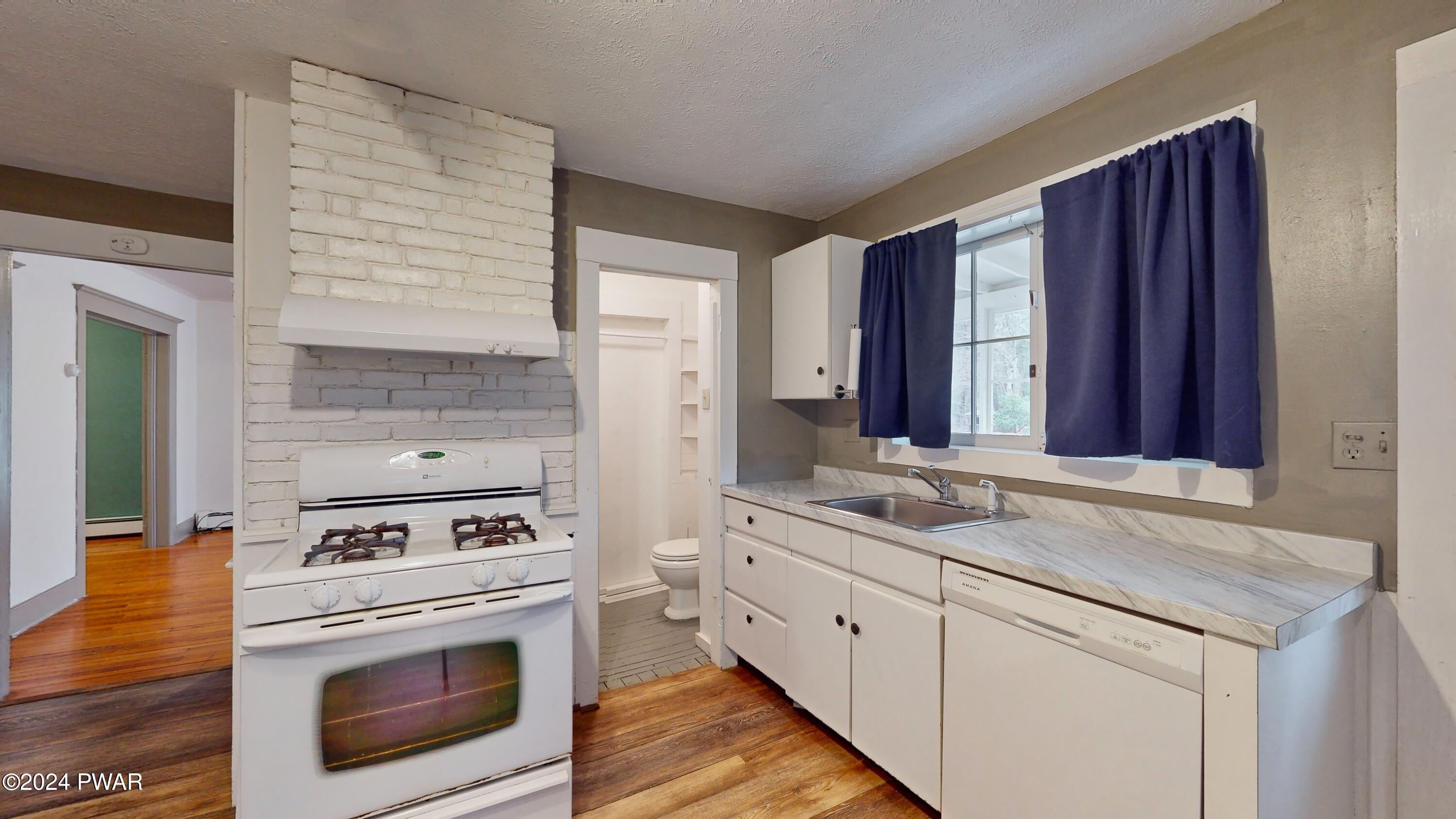108 9th Street Milford, PA 18337 - Photo 11 of 38 a kitchen with stainless steel appliances granite countertop a stove and a sink