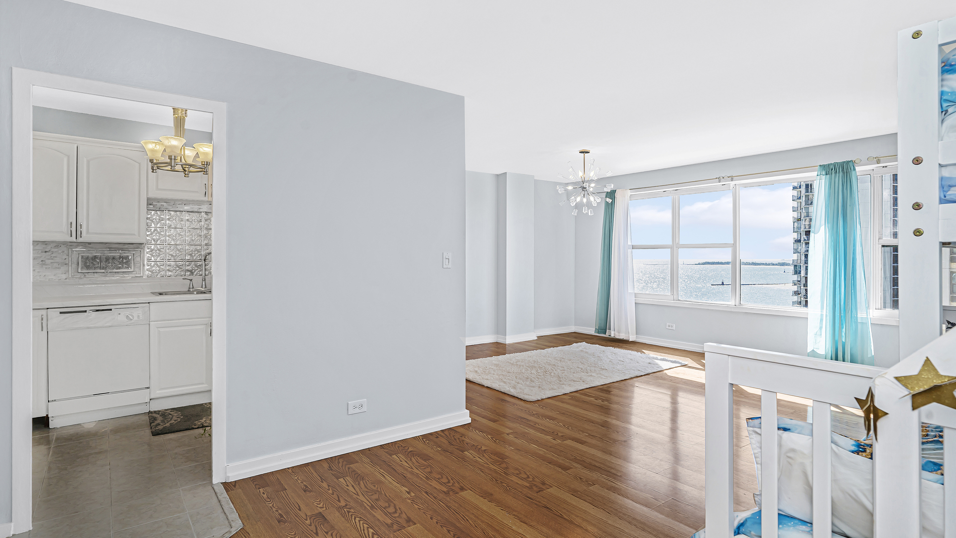 6157 North Sheridan Road, Unit 18K Chicago, IL 60660 - Photo 2 of 14 a view of empty room with wooden floor and fan