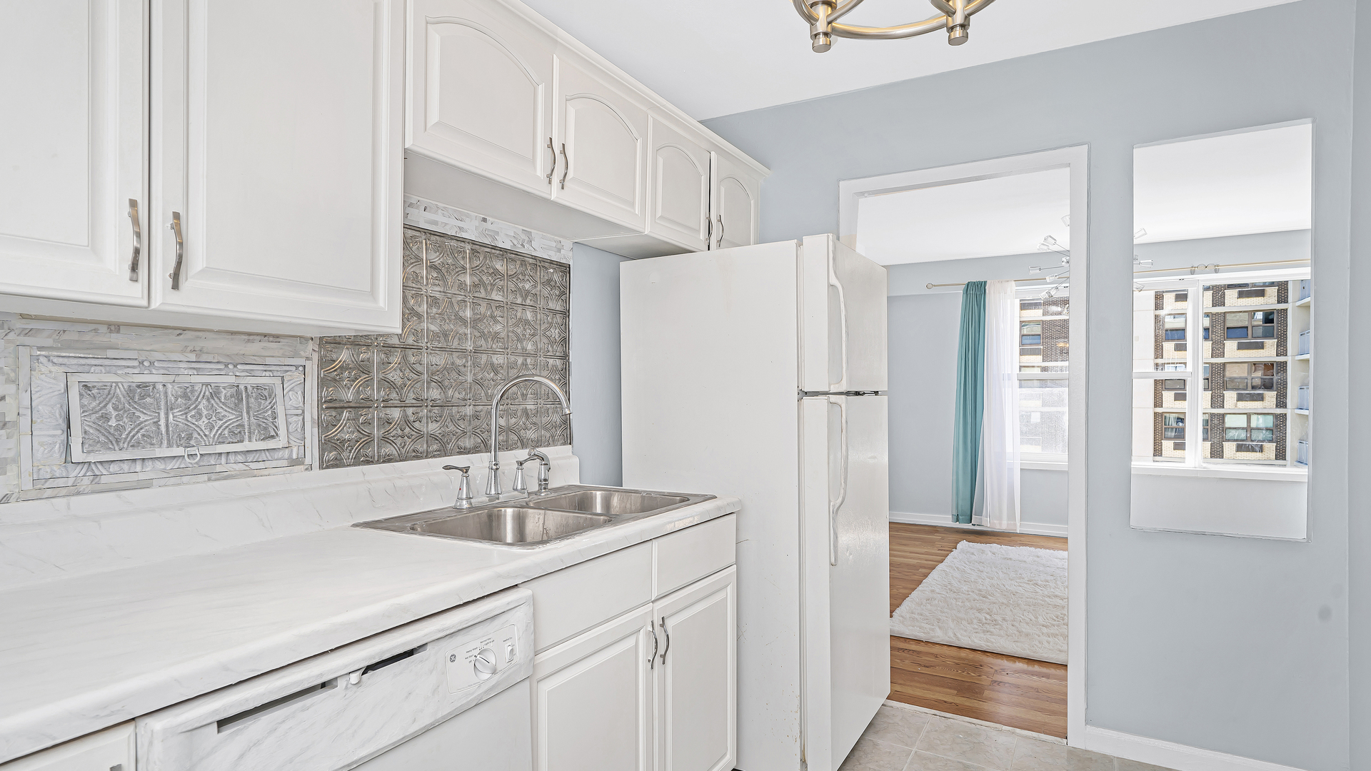 6157 North Sheridan Road, Unit 18K Chicago, IL 60660 - Photo 5 of 14 a kitchen with stainless steel appliances a sink and a refrigerator