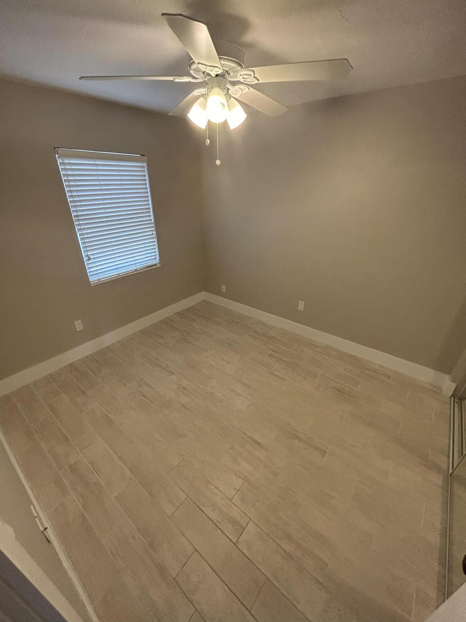 2004 Southwest 131st Place Miami, FL 33175 - Photo 2 of 16 a view of a small space with wooden floor and fan