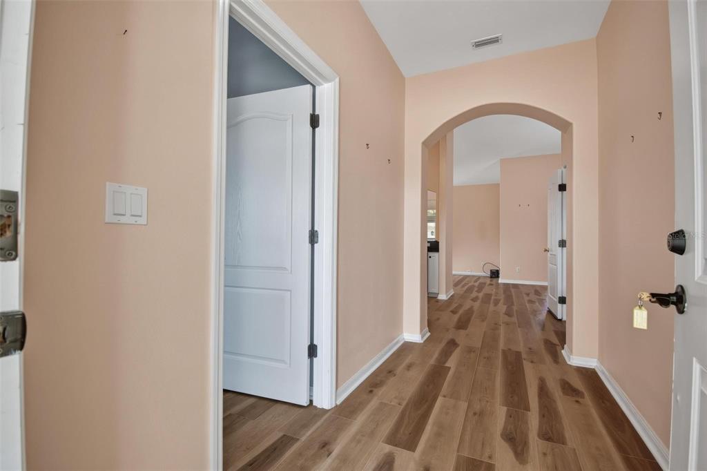 33 Summerwind Circle, Unit 101 Palm Coast, FL 32137 - Photo 11 of 45 a view of a hallway with wooden floor and a bathroom