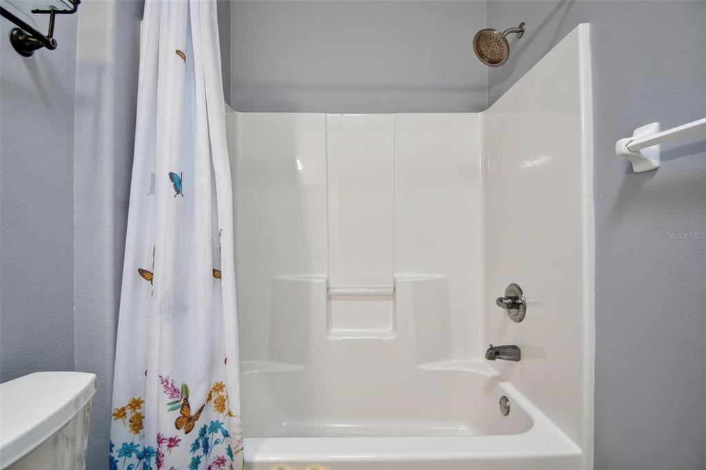33 Summerwind Circle, Unit 101 Palm Coast, FL 32137 - Photo 17 of 45 a bathroom with a bathtub and a shower