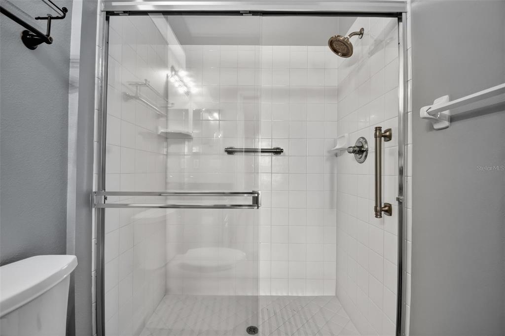 33 Summerwind Circle, Unit 101 Palm Coast, FL 32137 - Photo 18 of 45 a bathroom with a shower and toilet