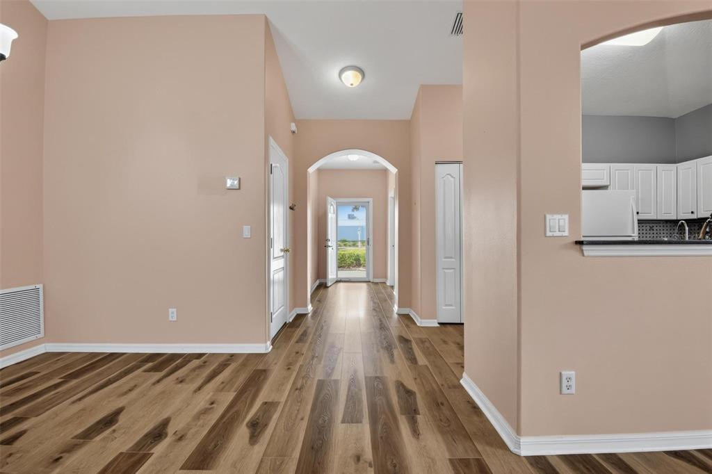 33 Summerwind Circle, Unit 101 Palm Coast, FL 32137 - Photo 21 of 45 a view of a room with wooden floor and a ceiling fan