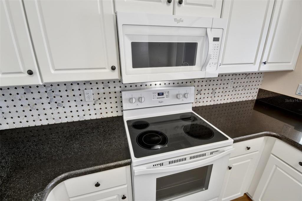 33 Summerwind Circle, Unit 101 Palm Coast, FL 32137 - Photo 32 of 45 a kitchen with a stove and a microwave