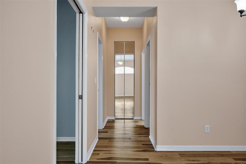 33 Summerwind Circle, Unit 101 Palm Coast, FL 32137 - Photo 37 of 45 a view of a hallway with wooden floor and a bathroom