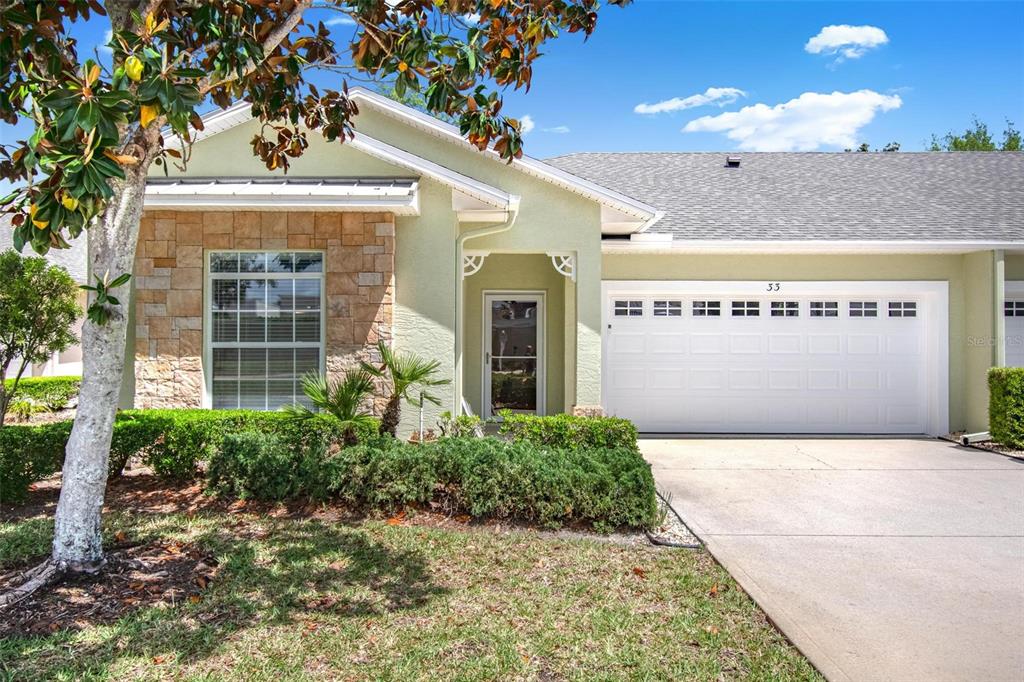 33 Summerwind Circle, Unit 101 Palm Coast, FL 32137 - Photo 7 of 45 a front view of a building with a garden