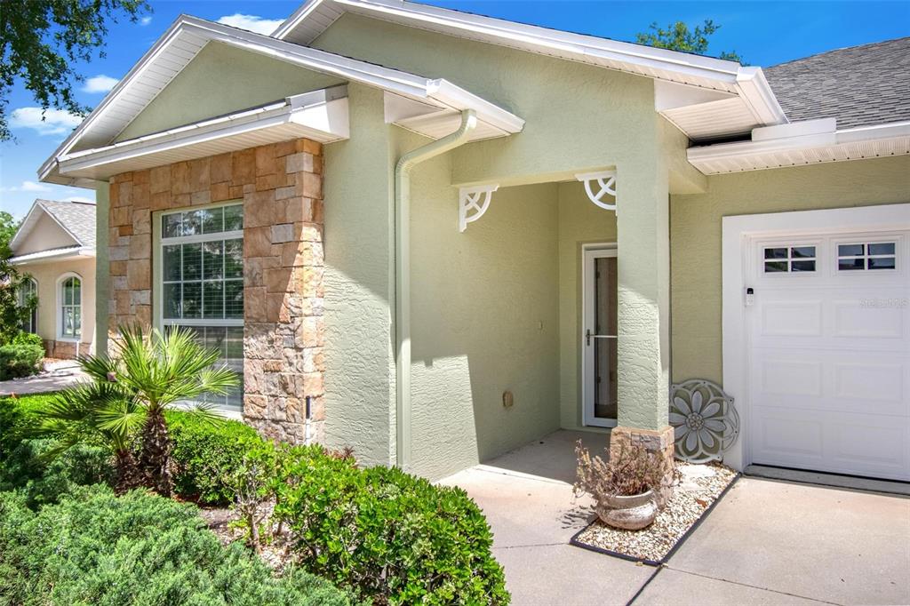 33 Summerwind Circle, Unit 101 Palm Coast, FL 32137 - Photo 8 of 45 a front view of a house with patio