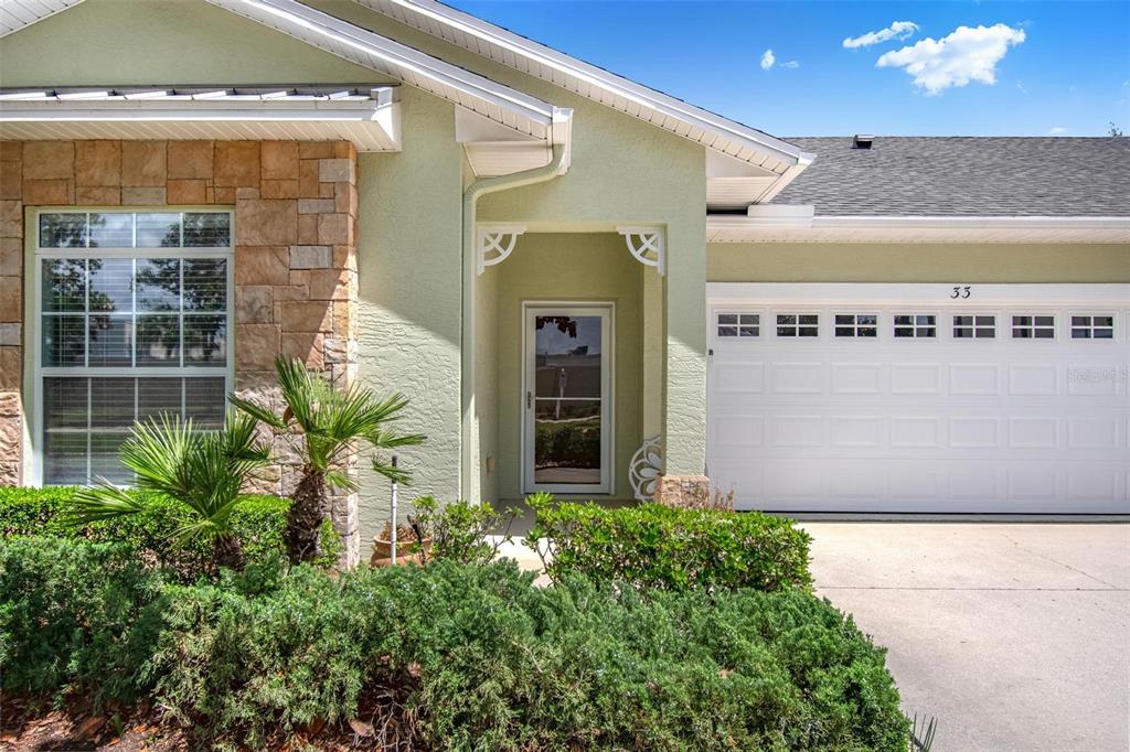 33 Summerwind Circle, Unit 101 Palm Coast, FL 32137 - Photo 9 of 45 a front view of a building with an entryway