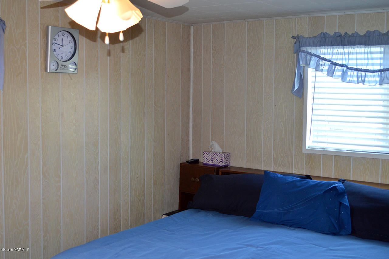 931 Barker Road Granger, WA 98932 - Photo 15 of 22 a room with wooden floor and furniture